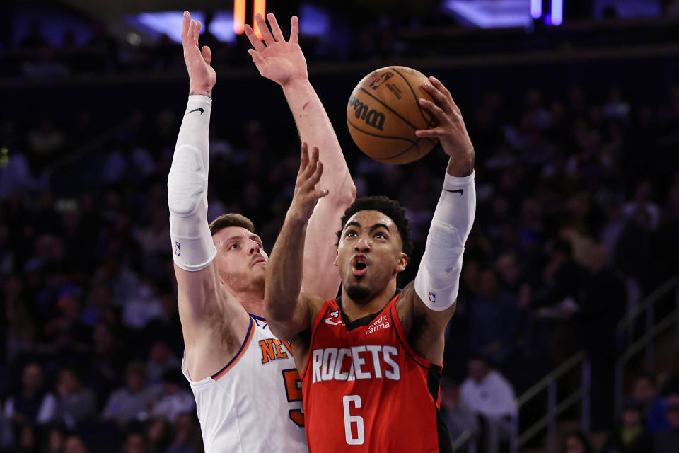 Houston Rockets forward Kenyon Martin Jr. (6) drives to the basket past New York Knicks center Isaiah Hartenstein, left, during the first half of an NBA basketball game Monday, March 27, 2023, in New York. (AP Photo/Adam Hunger)