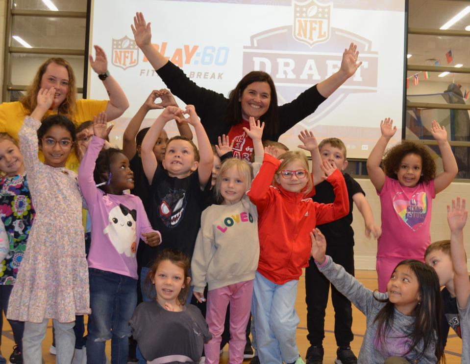 Jessica Day, center back, and her kindergarten class, celebrate winning $1,000 as the Detroit Lions local recipient of the American Heart Association's NFL Play 60 grant. As part of winning the award, Day will also get to make a pick during the 2024 NFL Draft in Detroit.