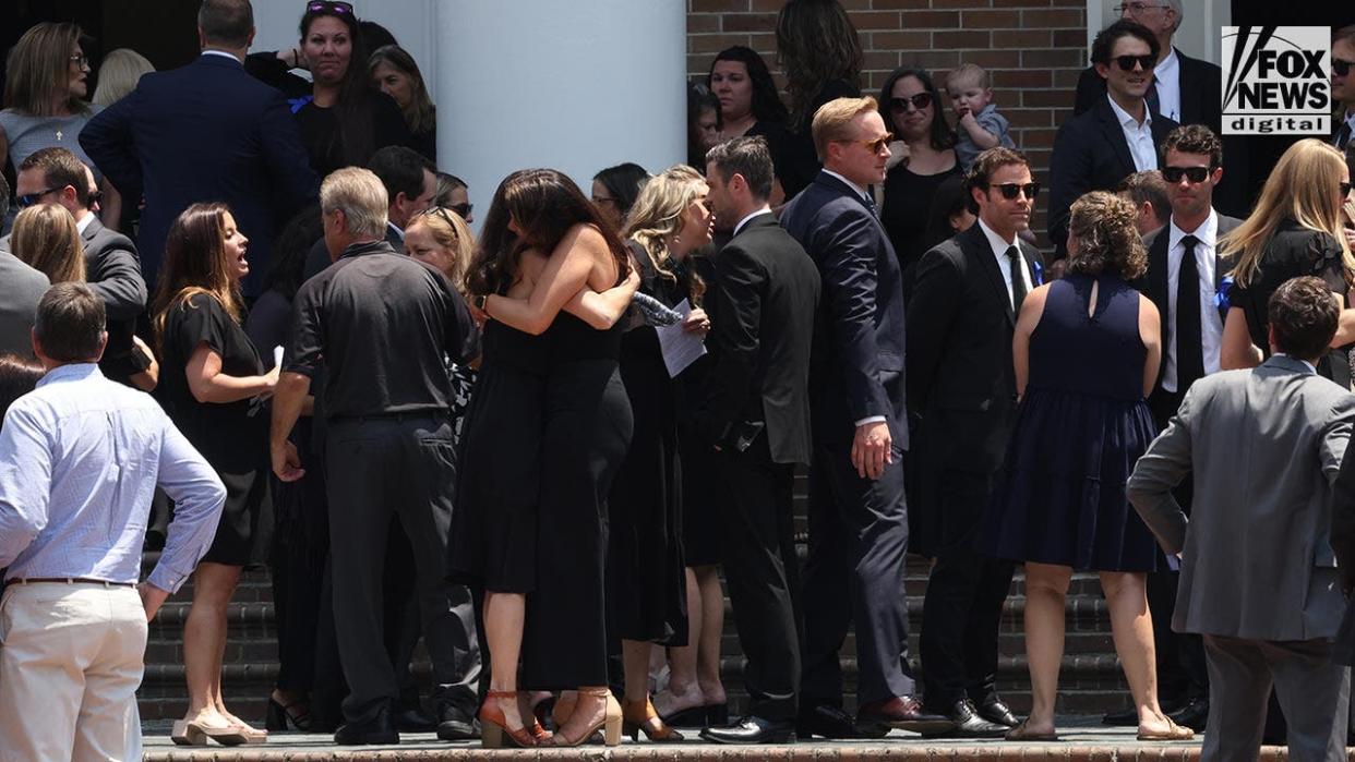 People attend a funeral a church for Johnny Wactor