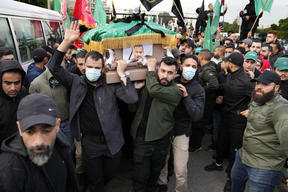 Hamas members carry the coffin of Saleh Arouri, one of the top Hamas commanders, who was killed in an apparent Israeli strike Tuesday, during his funeral in Beirut, Lebanon, Thursday, Jan. 4, 2024. (AP Photo/Hussein Malla)