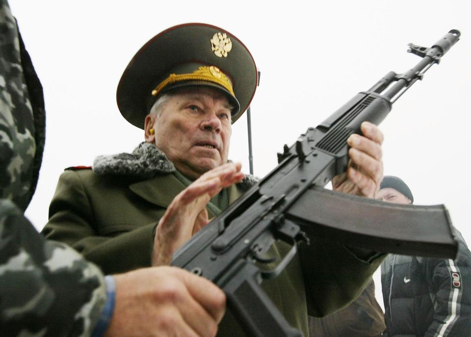 Mikhail Kalashnikov with an AK-74 assault rifle