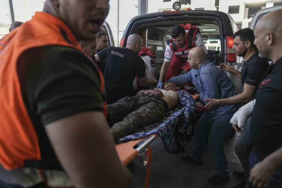 An injured Palestinian is carried into a hospital during an Israeli military raid in the Jenin refugee camp, a militant stronghold in the occupied West Bank, Monday, July 3, 2023. Israeli drones struck targets in the area early Monday and hundreds of troops were deployed. Palestinian health officials said at least five Palestinians were killed. (AP Photo/Nasser Nasser)