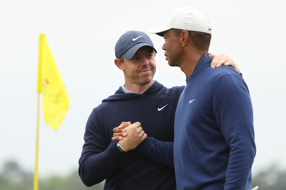 Rory McIlroy shakes hands with Tiger Woods.