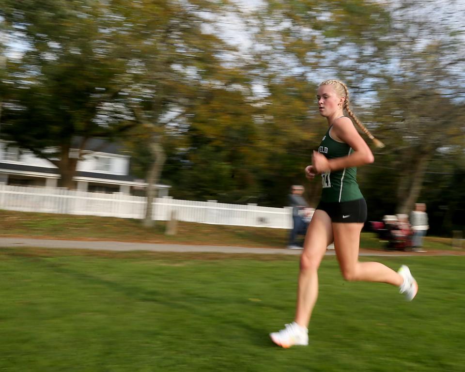 Marshfield’s Meredith Miller is a blur of motion during a lap of the athletic fields during their dual meet against Hingham at Hingham High on Wednesday, Oct. 11, 2023. She would place fourth with a time of 20:05.4 Marshfield boys won 27-28 while Marshfield girls won 19-36.