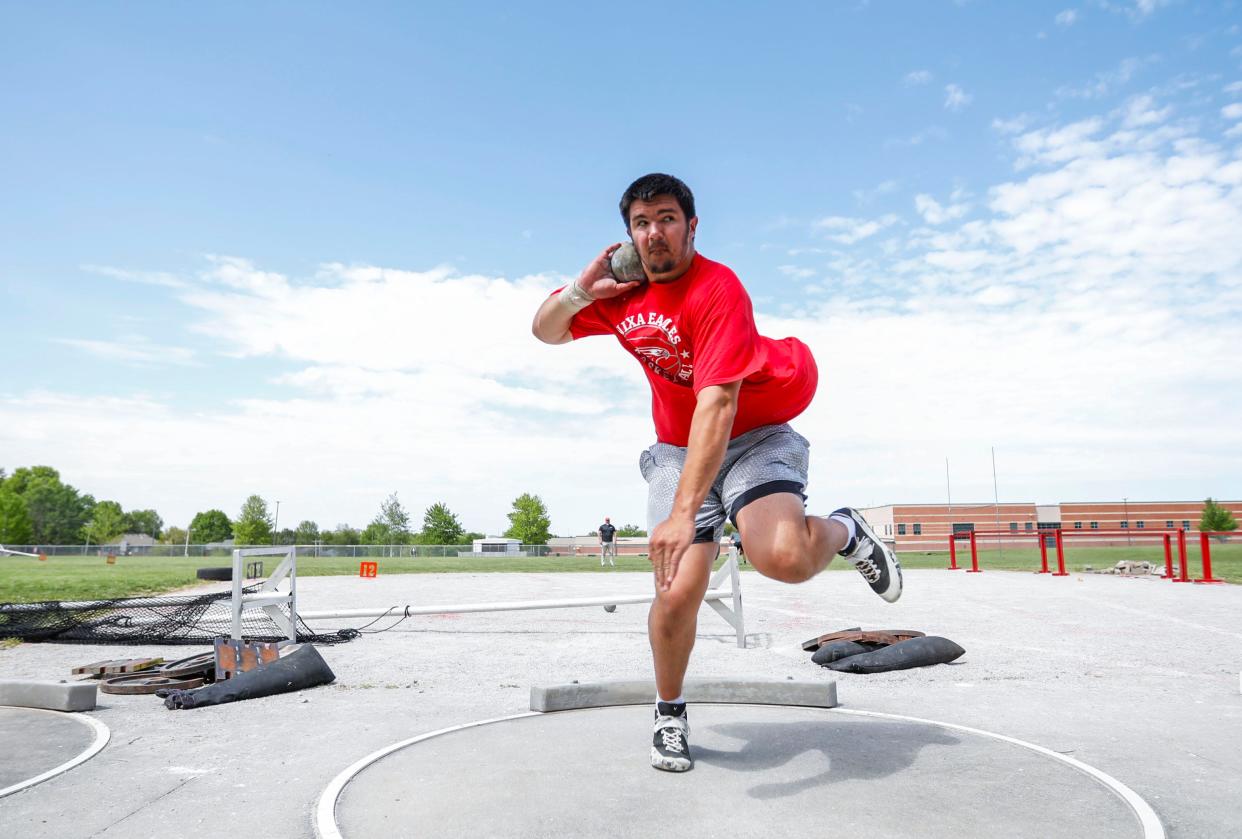 Jackson Cantwell spins around as he practices throwing a shotput during track and field practice at Nixa High School on Wednesday, April 24, 2024.