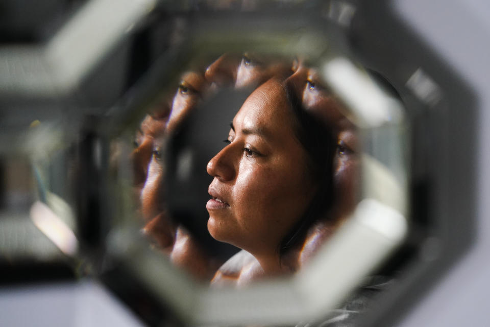 Lucia Altamirano, reflected in a mirror, speaks during an interview with The Associated Press in Philadelphia, Wednesday, Oct. 6, 2021. Philadelphia parents who don’t speak English say they’ve long been excluded from parts of their children’s education because of language barriers, an issue that's been exacerbated by the pandemic and the return to in-person learning. (AP Photo/Matt Rourke)