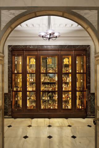 <p>COURTESY OF SCARFES BAR AT ROSEWOOD LONDON</p> Scarfes Bar's dramatic whiskey wall in the Rosewood London hotel