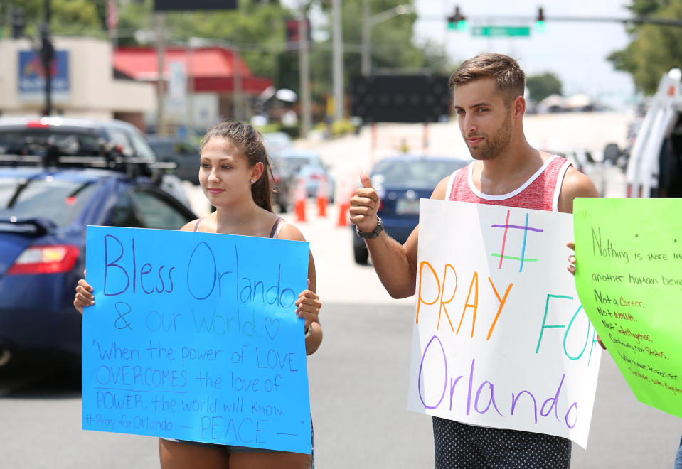 <p>People hold a vigil outside the Orlando Regional Medical Center in the aftermath of a mass shooting in Orlando, Florida, on June 12, 2016. (GREGG NEWTON/AFP/Getty Images) </p>