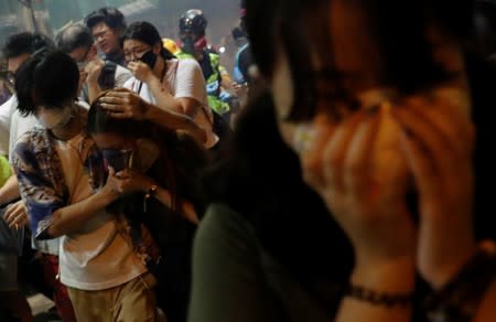 Anti-extradition bill protesters react after the police fired tear gas to disperse the demonstration at Sham Shui Po, in Hong Kong