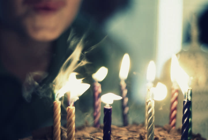 A boy out candles on his birthday.