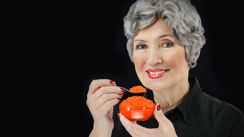 Woman eating caviar