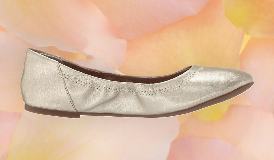 A photo of gold ballet flats on a colorful background.