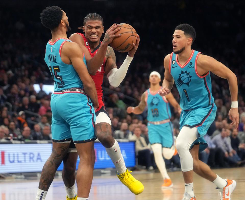 Dec 2, 2022; Phoenix, AZ, USA; Phoenix Suns guard Cameron Payne (15) draws the charging foul on Houston Rockets guard Jalen Green (4) at Footprint Center. Mandatory Credit: Joe Rondone-Arizona Republic