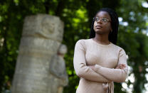 In this photo taken on Monday, June 22, 2020, young activist for Belgian Youth Against Racism, Eunice Yahuma, stands in front of the Monument to the Colonial Pioneers in Halle, Belgium. Yahuma, a local leader of both Belgian Youth Against Racism and the youth division of the Christian democrats, feels that it is time for debate and discussion about Belgium's grim history in Africa. (AP Photo/Virginia Mayo)