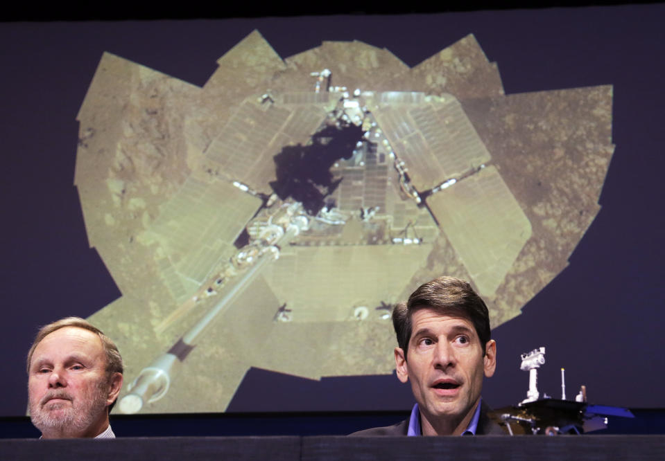 John Callas, Mars Exploration Rovers project manager, right, and Ray Arvidson, deputy principal investigator, speak at a news conference marking the 10th anniversary of the NASA Mars Opportunity rover mission, at a news conference at Jet Propulsion Laboratory in Pasadena, Calif., Thursday, Jan. 23, 2014. Projected at rear is what Callas described as a 'selfie,' a self-portrait of the Rover's solar panels, that have remained relatively dust-free longer than expected, extending the spacecraft's life. (AP Photo/Reed Saxon)