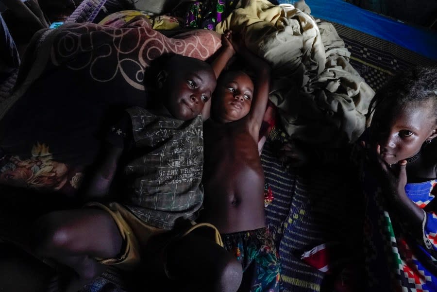 Children rest in a hut on the side of the road crowded with some 140 people in Niamey, Niger, Monday, July 31, 2023. (AP Photo/Sam Mednick)