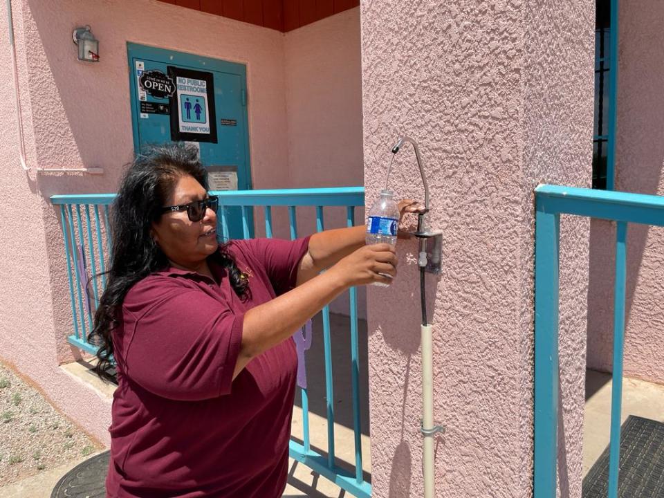 Selina Jesus, senior director of programs with the Native American Advancement Foundations, fills her bottle with water coming from SOURCE hydropanels.