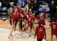 FILE - North Carolina State celebrates a win over Texas in an Elite Eight college basketball game in the women's NCAA Tournament, Sunday, March 31, 2024, in Portland, Ore. N.C. State’s men’s basketball team is in the Final Four for the first time since 1983, while the Wolfpack women are in the Final Four for the first time since 1998.(AP Photo/Steve Dykes, FIle)