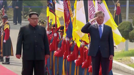 South Korean President Moon Jae-in salutes next to North Korean leader Kim Jong Un during a ceremony at the inter-Korean summit at the truce village of Panmunjom, in this still frame taken from video, South Korea April 27, 2018. Host Broadcaster via REUTERS TV