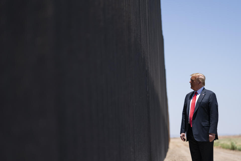 FILE - In this June 23, 2020, file photo, President Donald Trump tours a section of the border wall in San Luis, Ariz. The Supreme Court is agreeing to review a Trump administration policy that makes asylum-seekers wait in Mexico for U.S. court hearings. As is typical, the court did not comment Monday in announcing it would hear the case. Because the court’s calendar is already full through the end of the year, the justices will not hear the case until 2021. (AP Photo/Evan Vucci, File)