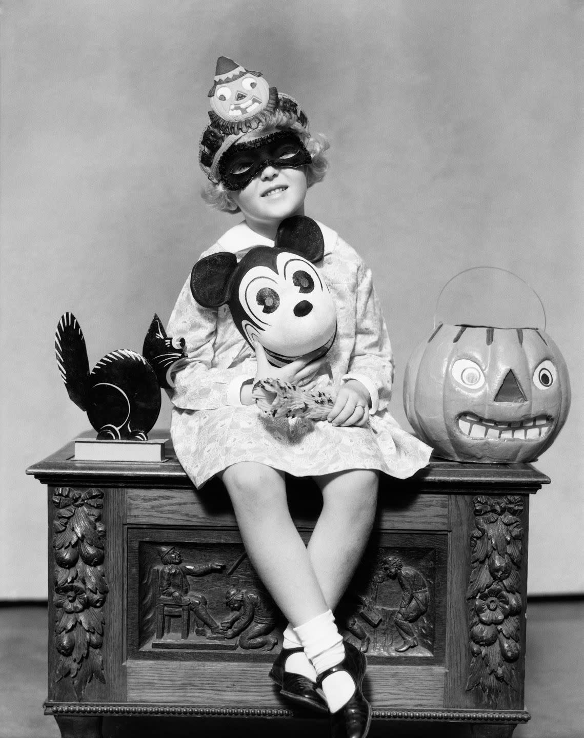 vintage halloween decorations held by a little girl