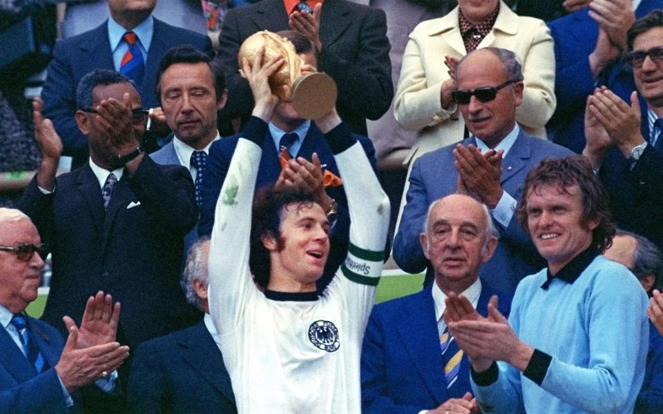 Beckenbauer lifts the World Cup in 1974 watched by his teammate Sepp Maier