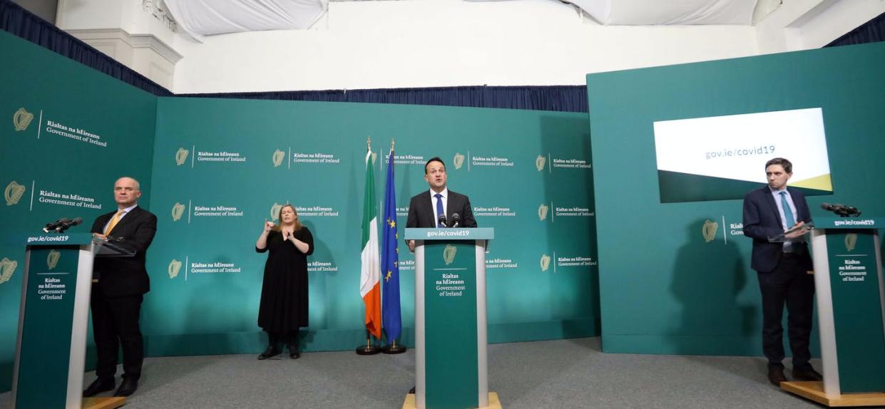 <span class="caption">Ireland's health minister, center, models social distancing at his nightly coronavirus press briefing March 27, 2020.</span> <span class="attribution"><a class="link " href="https://www.gettyimages.com/detail/news-photo/chief-medical-officer-tony-holohan-taoiseach-leo-varadkar-news-photo/1208436468?adppopup=true" rel="nofollow noopener" target="_blank" data-ylk="slk:Sasko Lazarov/RollingNews.ie/PA Images via Getty Images;elm:context_link;itc:0;sec:content-canvas">Sasko Lazarov/RollingNews.ie/PA Images via Getty Images</a></span>