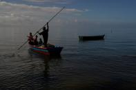 FILE PHOTO: Local resident Roemoni Tubivuna departs for a fishing outing with his grandsons at Veivatuloa Village, Fiji