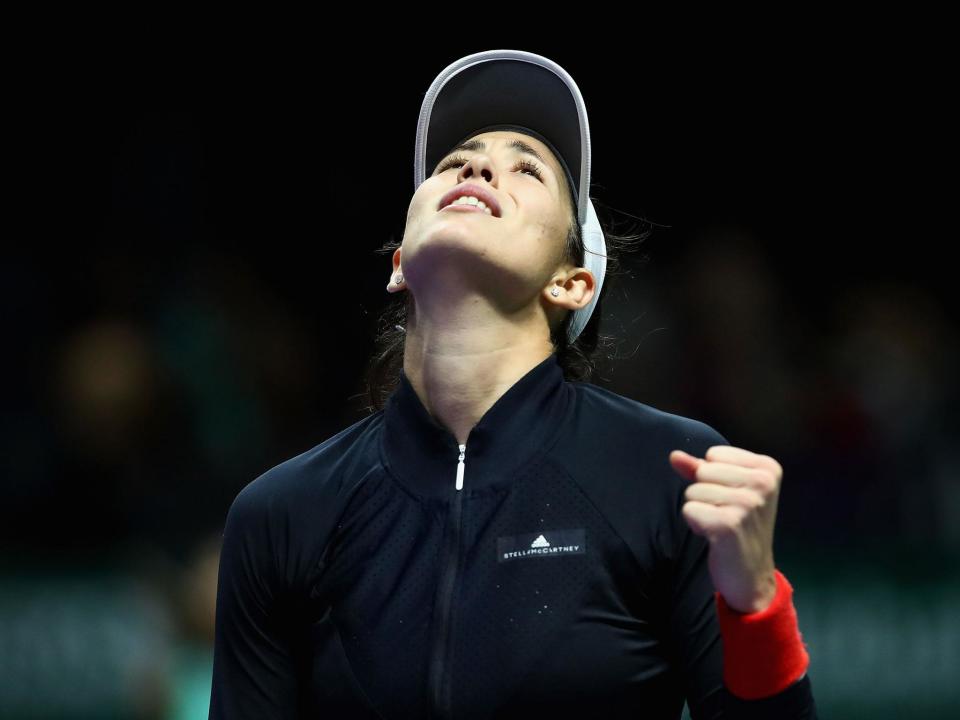 Garbine Muguruza celebrates after holding on for victory: Getty