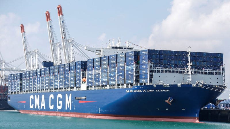 A photo of a large blue ship filled with containers. 