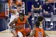 Virginia Tech's Justyn Mutts (25) gets pressure under the basket from Notre Dame's Nate Laszewski, left, during the first half of an NCAA college basketball game Wednesday, Jan. 27, 2021, in South Bend, Ind. (AP Photo/Robert Franklin)