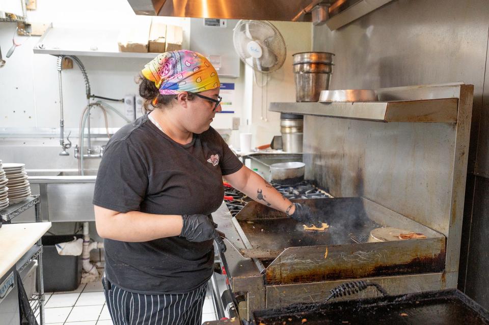 Myranda Kreiman grills a beef patty for a breakfast slopper at B Street Cafe on Tuesday, May 7, 2024.