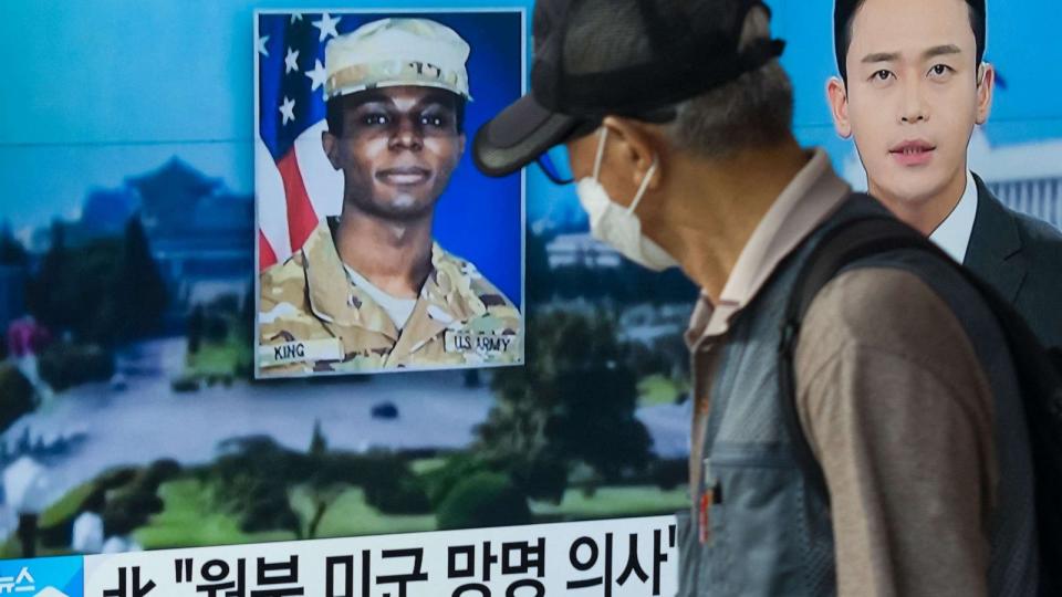PHOTO: (FILES) In this photo taken in Seoul on August 16, 2023, a man walks past a television showing a news broadcast featuring a photo of US soldier Travis King (C). (Anthony Wallace/AFP via Getty Images)