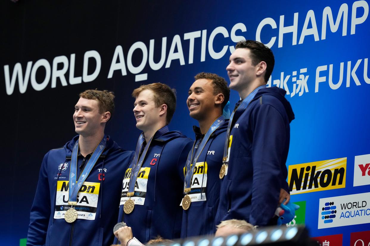 United States gold medalists Ryan Murphy, Nic Fink, Dare Rose and Jack Alexy stand on the podium during the medal ceremony for the men's 4x100m medley relay at the World Swimming Championships in Fukuoka, Japan, Sunday, July 30, 2023. (AP Photo/Eugene Hoshiko)