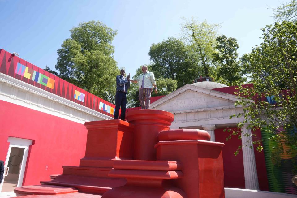 Artist Jeffrey Gibson, right, poses with artist Mark Bradford at the U.S. pavilion during the media open day at the 60th Biennale of Arts in Venice, Italy, Tuesday, April 16, 2024. A Mississippi Choctaw of Cherokee descent, Gibson is the first Native American to represent the United States solo at the Venice Biennale, the world’s oldest contemporary art show. Gibson mixes Western modernism and Native American craft in his vibrantly hued paintings and sculptures. (AP Photo/Luca Bruno)