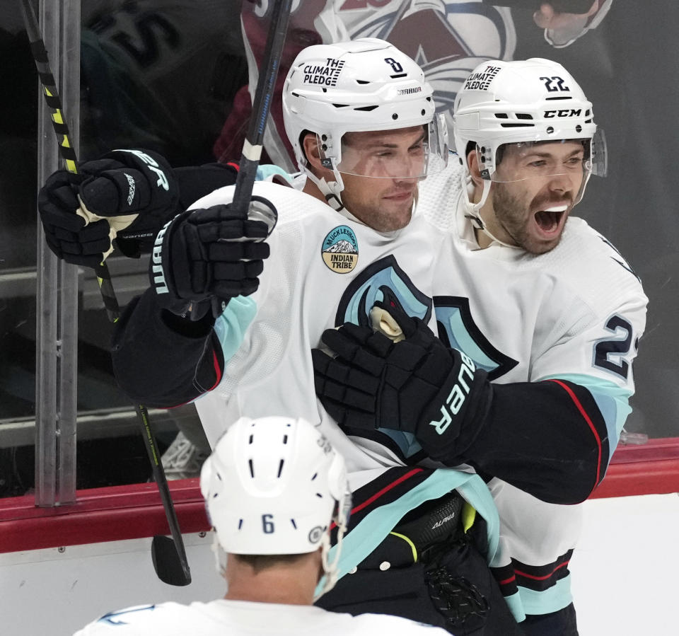 Seattle Kraken right wing Oliver Bjorkstrand, right, celebrates scoring the go-ahead goal with defenseman Brian Dumoulin in the third period of an NHL hockey game against the Colorado Avalanche on Thursday, Nov. 9, 2023, in Denver. (AP Photo/David Zalubowski)