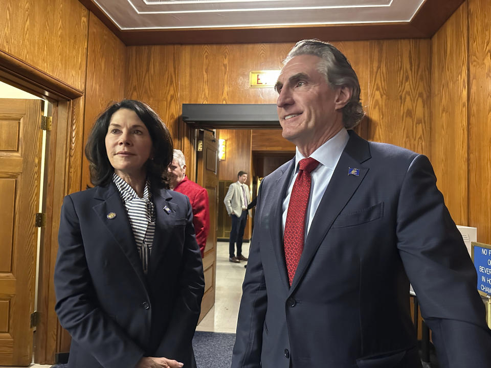North Dakota Republican Gov. Doug Burgum, at right, and Lt. Gov. Tammy Miller, at left, stand in the state House of Representatives on Monday, Oct. 23, 2023, in the state Capitol in Bismarck, N.D., before Burgum addressed the Legislature. Lawmakers were back in Bismarck to begin a special session to primarily address a major budget bill voided last month by the state Supreme Court. (AP Photo/Jack Dura)