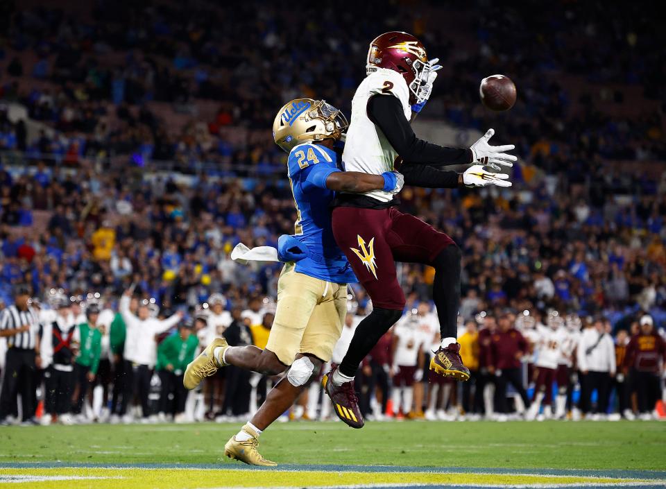 Elijhah Badger #2 of the Arizona State Sun Devils makes a touchdown pass reception against Jaylin Davies #24 of the UCLA Bruins in the second half at Rose Bowl Stadium on Nov. 11, 2023, in Pasadena, California.