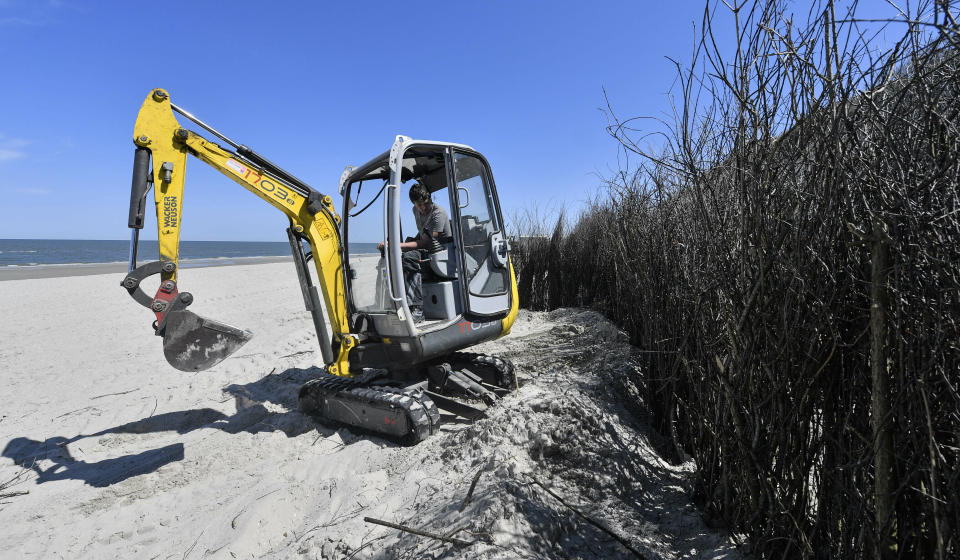 In this photo taken on Wednesday, May 15, 2019, coastal management workers build up the defense against flooding and erosion on the car-free environmental island of Langeoog in the North Sea, Germany. Concerns about climate change have prompted mass protests across Europe for the past year and are expected to draw tens of thousands onto the streets again Friday, May 24. For the first time, the issue is predicted to have a significant impact on this week’s elections for the European Parliament. (AP Photo/Martin Meissner)
