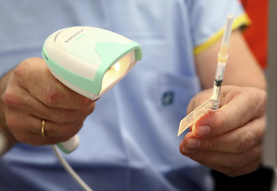 A vial of the Pfizer vaccine is scanned before administered at the Royal Prince Alfred Hospital Vaccination Hub in Sydney, Australia, Monday, Feb. 22, 2021. Australia has started its COVID-19 vaccination program days after its neighbor New Zealand with both governments deciding their pandemic experiences did not require regulation short cuts. (Toby Zerna/Pool via AP)