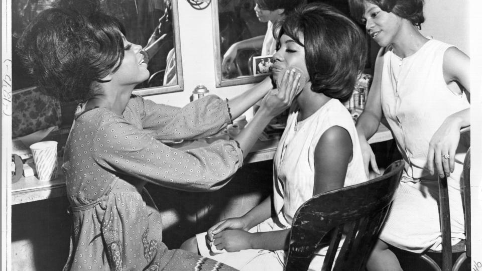 the supremes sit in a dressing room and help each other apply makeup and get ready