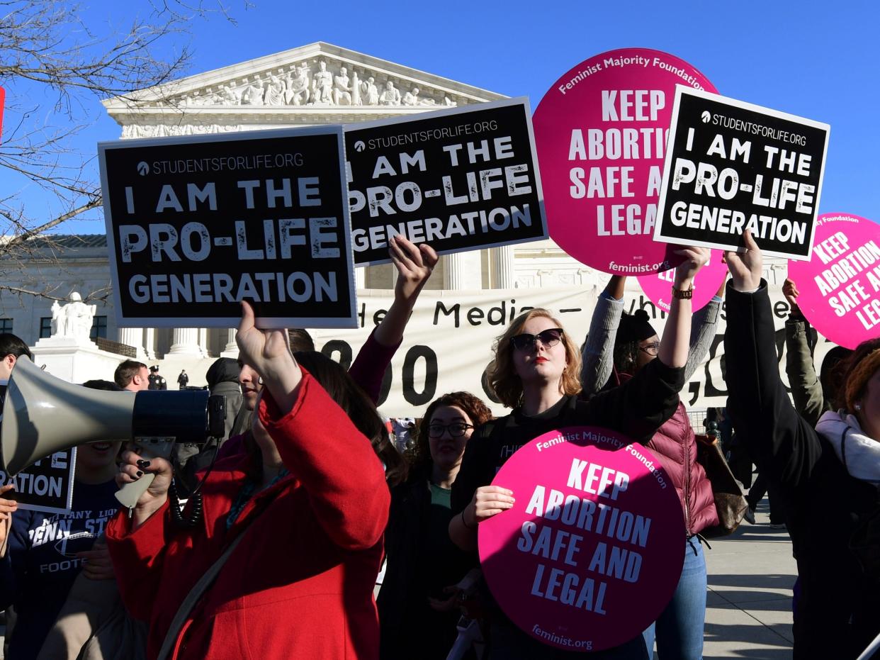 Protesters on both sides of the abortion issue gather outside the Supreme Court in Washington, Friday, Jan. 19, 2018, during the March for Life.