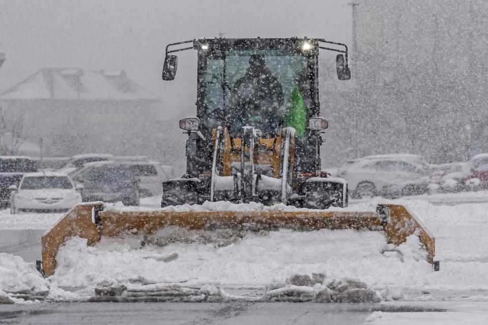 A truck plows the snow of a parking lot along Wilmington's Riverfront, Friday, Jan. 19, 2024.