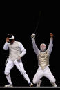 LONDON, ENGLAND - NOVEMBER 27: Dmitri Rigine (L) of Russia looks dejected as Richard Kruse celebrates winning the gold medal win in the Men's Foil Team Final at the Fencing Invitational, part of the London Prepares series at ExCel on November 27, 2011 in London, England (Photo by Dean Mouhtaropoulos/Getty Images)