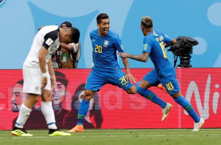 Soccer Football - World Cup - Group E - Brazil vs Costa Rica - Saint Petersburg Stadium, Saint Petersburg, Russia - June 22, 2018 Brazil's Neymar and Roberto Firmino celebrate after Philippe Coutinho (not pictured) scored their first goal REUTERS/Henry Romero