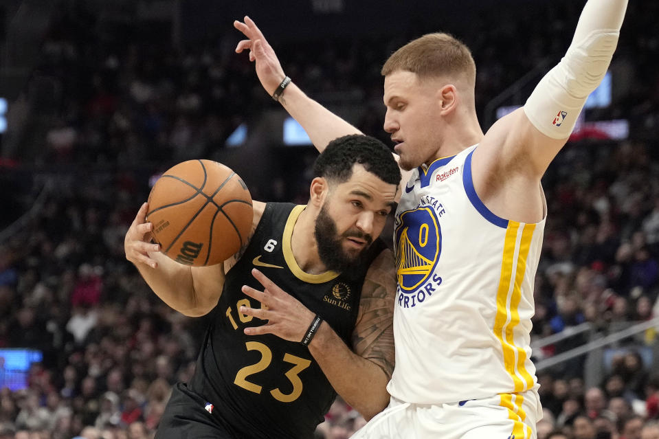 Toronto Raptors guard Fred VanVleet (23) tries to move past Golden State Warriors guard Donte DiVincenzo (0) during the first half of an NBA basketball game in Toronto, Sunday, Dec. 18, 2022. (Frank Gunn/The Canadian Press via AP)