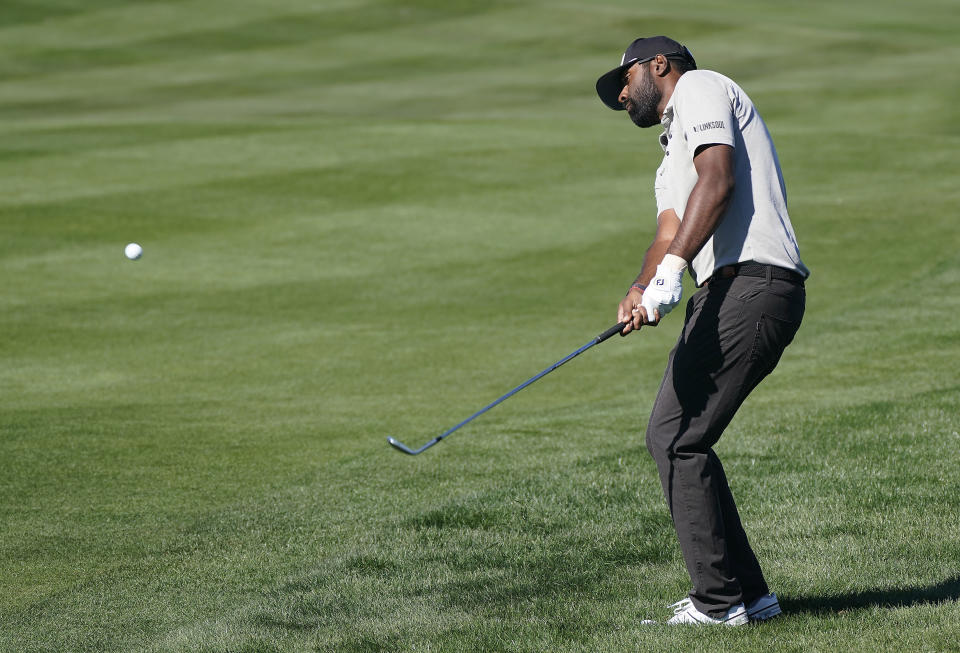 Sahith Theegala chips off the eighth hole fairway during the Phoenix Open golf tournament Friday, Feb. 11, 2022, in Scottsdale, Ariz. (AP Photo/Darryl Webb)