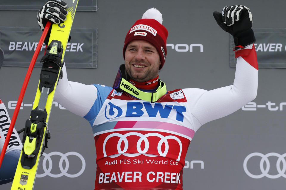 Switzerland's Beat Feuz stands on the podium after winning the men's World Cup downhill skiing race Saturday, Dec. 7, 2019, in Beaver Creek, Colo. (AP Photo/John Locher)