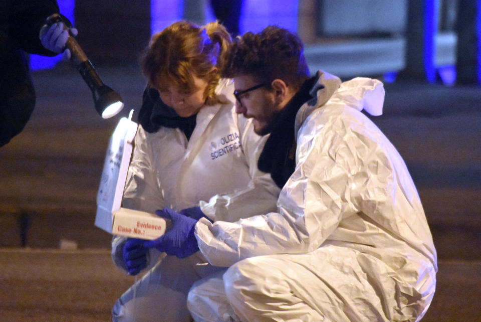 Italian forensic police collect evidence in an area after a shootout between police and a man near a train station in Milan's Sesto San Giovanni neighborhood, Italy, early Friday, Dec. 23, 2016. Italy's interior minister Marco Minniti says the man killed in an early-hours shootout in Milan is "without a shadow of doubt" the Berlin Christmas market attacker Anis Amri. (AP Photo/Daniele Bennati)