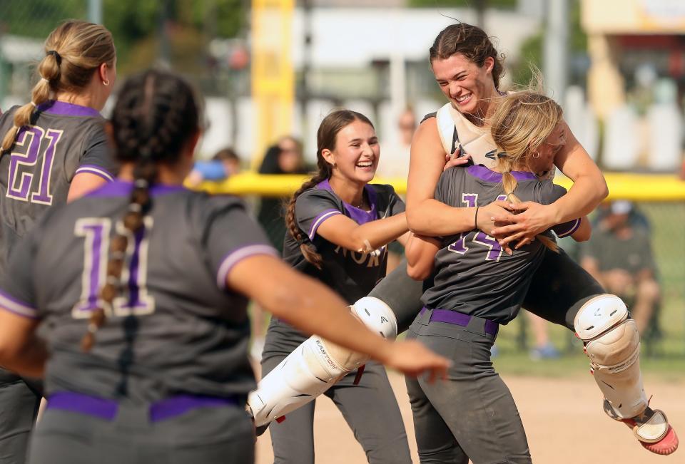 North Kitsap catcher Mackenzie Phillips leaps into the arms of pitcher Reese Anderson as they celebrate their Class 2A title game win over Ridgefield at Carlon Park in Selah on Saturday, May 27, 2023.